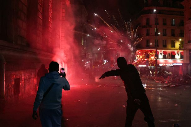 Demonstrators gesture as clashes occure on the outskirts of a gathering for the election night following the second round results of France’s legislative election at Republique Square in Paris on the night of July 8, 2024. A broad left-wing coalition was leading a tight French legislative election, ahead of both President’s centrists and the far right with no group winning an absolute majority, projections showed. (Photo by Alain JOCARD / AFP) (Photo by ALAIN JOCARD/AFP via Getty Images)